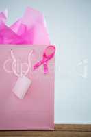 Close-up of pink spotted Breast Cancer Awareness ribbon on shopping bag