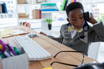 Businessman talking on smartphone while working in office