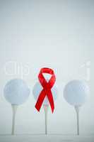 Red AIDS Awareness ribbon on golf ball