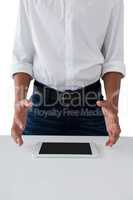 Teenage boy trying to hold the digital tablet