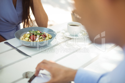 Woman having vegetable salad at restaurant