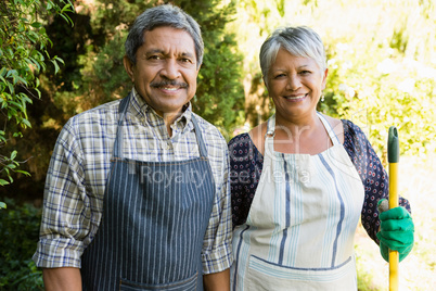 Senior couple standing in garden on a sunny day