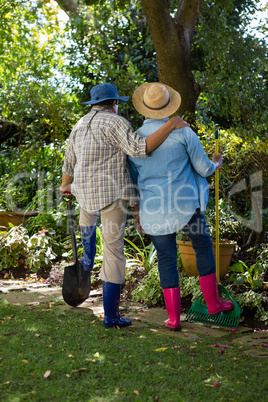 Senior couple standing in garden on a sunny day