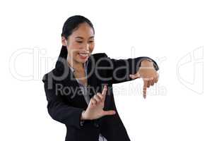 Happy businesswoman with finger frame gesture