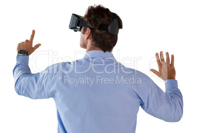 Rear view of businessman gesturing while wearing vr glass