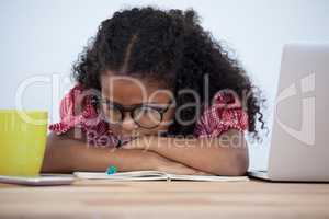Close up of bored businesswoman leaning on desk