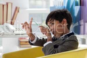 Bored businessman playing with rubber band in office