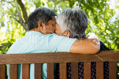 Senior couple kissing at the park