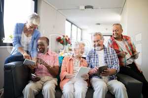 Happy senior people using tablet computers