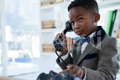 Businessman looking up while talking on mobile phone