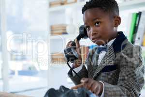 Businessman looking up while talking on mobile phone