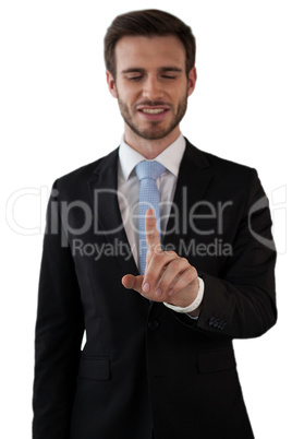 Smiling businessman touching index finger on interface