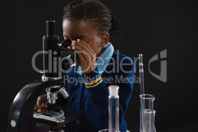 Schoolgirl using microscope