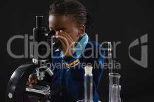 Schoolgirl using microscope
