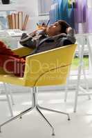 Business talking on smart phone while sitting on armchair