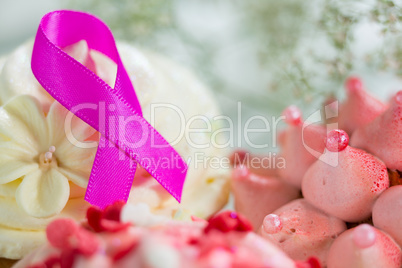 Close-up of pink Breast Cancer Awareness ribbon on cupcake