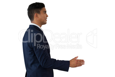 Side view of young businessman extending arms for handshake