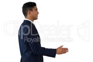 Side view of young businessman extending arms for handshake