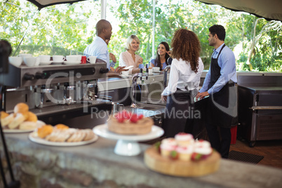 Waiter and waitresses taking order at counter