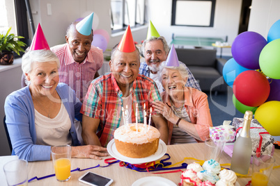Portrait of cheerful senior friends celebrating birthday