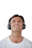 Smiling mature man wearing headphones looking up