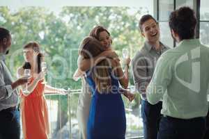 Group of friends congratulating couple during party