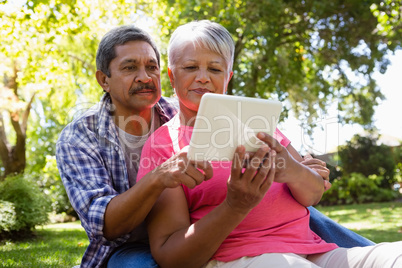 Senior couple using digital tablet