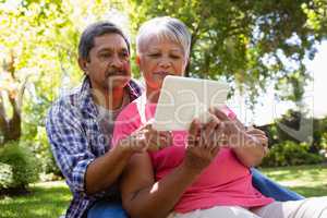 Senior couple using digital tablet