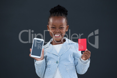 Portrait of cheerful businesswoman holding smart phone and red card