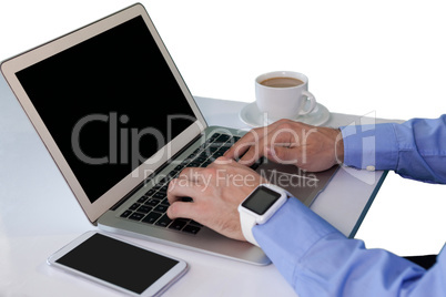 High angle view businessman using laptop at table