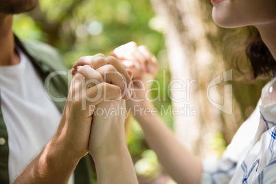 Mid-section of couple holding hands