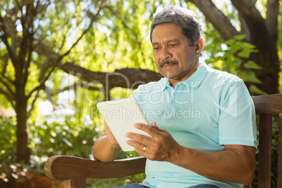 Senior man using digital tablet