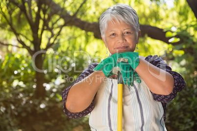 Senior woman standing in garden on a sunny day