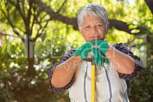 Senior woman standing in garden on a sunny day
