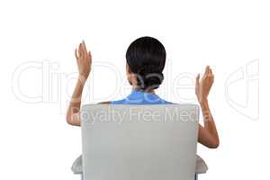 Rear view of businesswoman using interface white sitting on chair