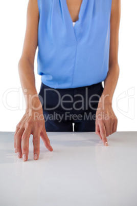 Mid section of creative businesswoman gesturing on table