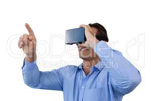 Smiling businessman pointing while wearing virtual reality simulator