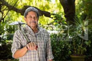 Senior man standing in garden on a sunny day