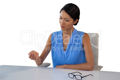 Young businesswoman looking at hand