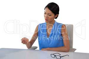 Young businesswoman looking at hand