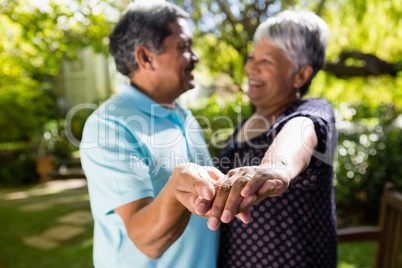 Senior couple dancing in the garden Senior couple dancing in the garden