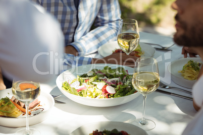 Close-up of food and wine glass on dining table