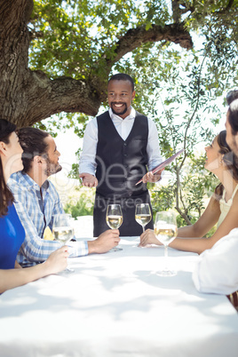 Friends placing order to waiter