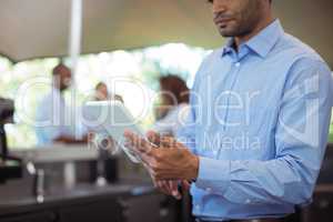 Waiter using digital tablet at outdoor cafÃ?Â©