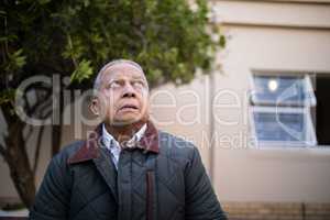 Retired senior man looking up