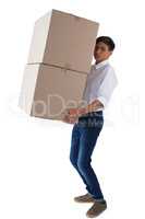 Boy carrying heavy boxes