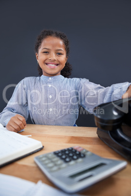 Portrait of smiling girl holding landline phone