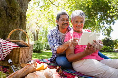 Senior couple using digital tablet