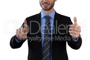 Mid section of businessman wearing suit while using invisible interface