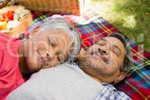 Senior couple laying on blanket